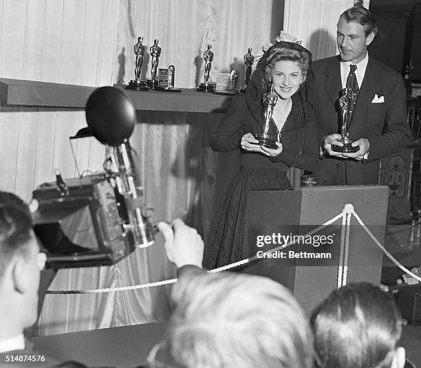 Los Angeles, CA: Shown with their "Oscars" are Joan Fontaine, left, who received her award for her stellar acting in "Suspicion" and Gary Cooper,...