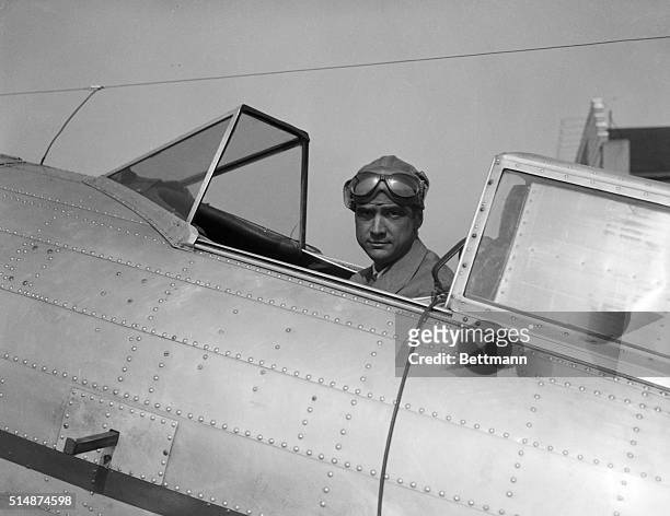 Howard Hughes, millionaire and film producer, sits in the cockpit of a small plane on May 14 in Chicago. He is destined for Los Angeles, on which he...