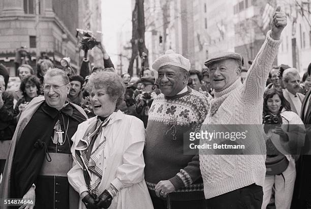 Cardinal O' Connor smiles alongside actress Maureen O'Hara, Police Commissioner Benjamin Ward, and Mayor Ed Koch. They are celebrating during the St....