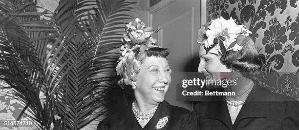 Washington, DC: Mrs. Dwight Eisenhower and Mrs. Richard Nixon sport new spring hats at a luncheon and fashion show in connection with the Cherry...