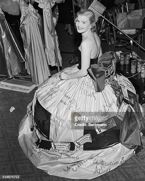 New York, NY: Mrs. Thomas Wyman, Jr. Is shown modeling a gown sponsored by the American Express company at the second annual Mardi Gras Ball tonight....