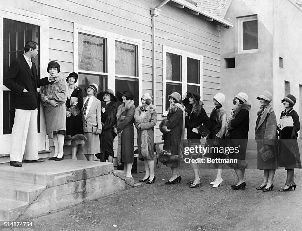 S: Hollywood, CA: Extras lined up in front of Paramount Studios. Photo.