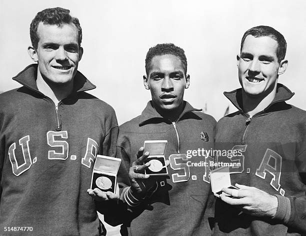 Melbourne, Australia: American athletes with their medals after sweeping to victory in the final of the 110 meters hurdles. L to r: Joel Shankle, who...
