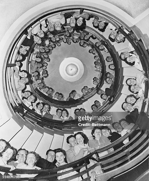 Brighton, England: Lined up on the impressive staircase at Butlin's Holiday Hotel in Brighton are 49 pairs of honeymooners, who were married just one...