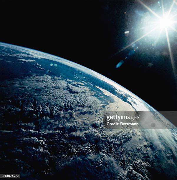 View of Earth from the Space Shuttle Discovery shows late afternoon sun on the Andes Mountains, with glare and heavy cloud illumination.