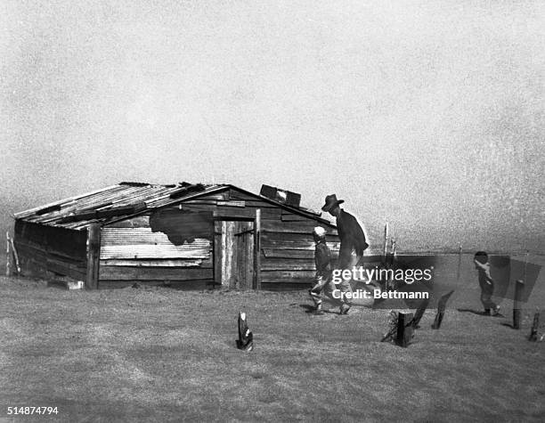 Farmer and his sons flee from an approaching dust storm in Oklahoma.