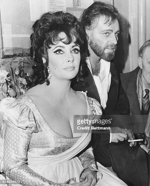 Richard Burton and his wife, Elizabeth Taylor, relax after their performances in the Christopher Marlowe classic "Dr. Faustus" at Burton's alma...