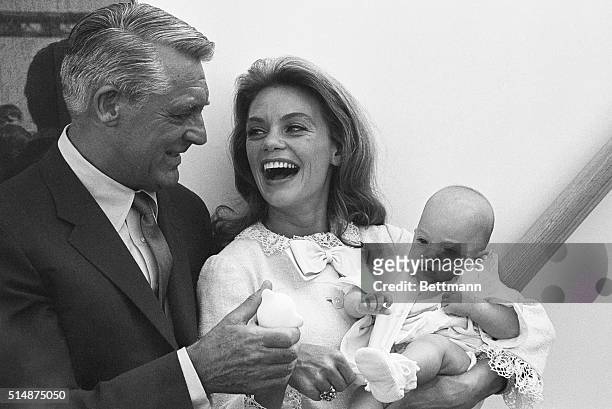Cary Grant, wife Dyan Cannon, and their daughter Jennifer, age 3 months old, just before boarding the SS Oriana, bound for England, to visit Grant's...