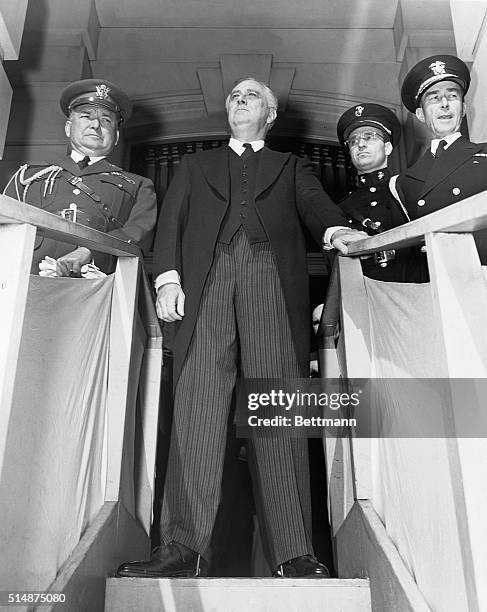 Grim President Franklin D. Roosevelt leaves the Capitol with his son James and several military aides after asking the joint session of Congress for...