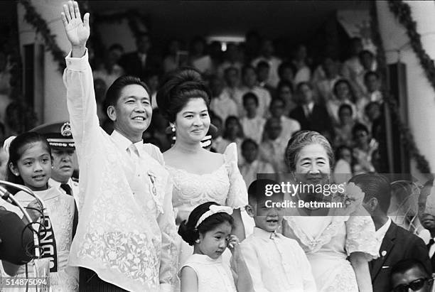 Standing with his family, Ferdinand Marcos waves to the crowd after his inauguration as the President of the Philippines on December 30, 1965