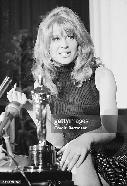 Julie Christie talks with reporters after winning the Academy Award for Best Actress, for her role in the movie Darling. 1966.