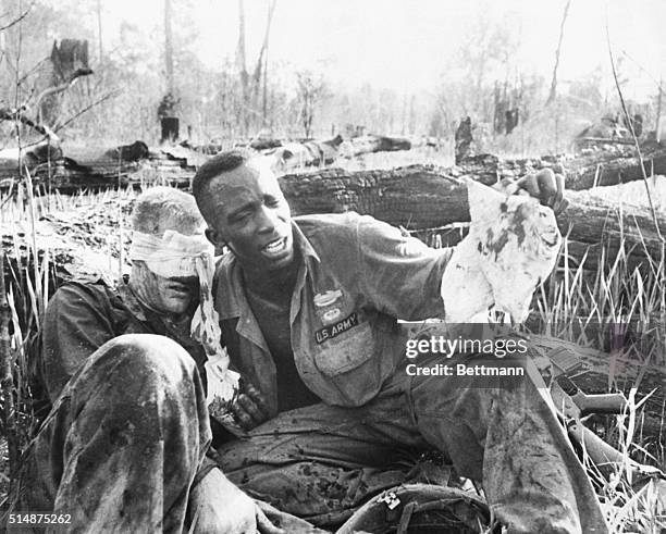 An US Army medic tries to help a wounded soldier in Vietnam.