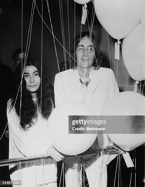 London: Beatle John Lennon and Japanese artist Yoko Ono examine exhibits at a showing of John's art works dedicated to Yoko at the Mayfair Gallery...