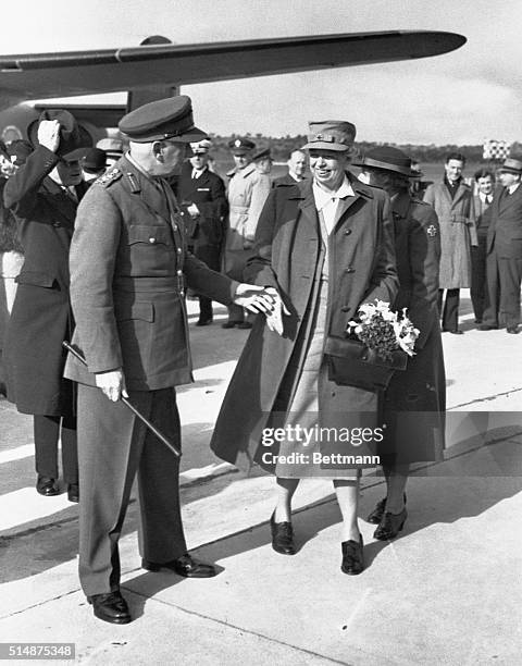 Eleanor Roosevelt, on a Red Cross tour, is greeted by Lieutenant General Robert Eichelberger of the U.S. Army and Governor General Lord Gowrie.