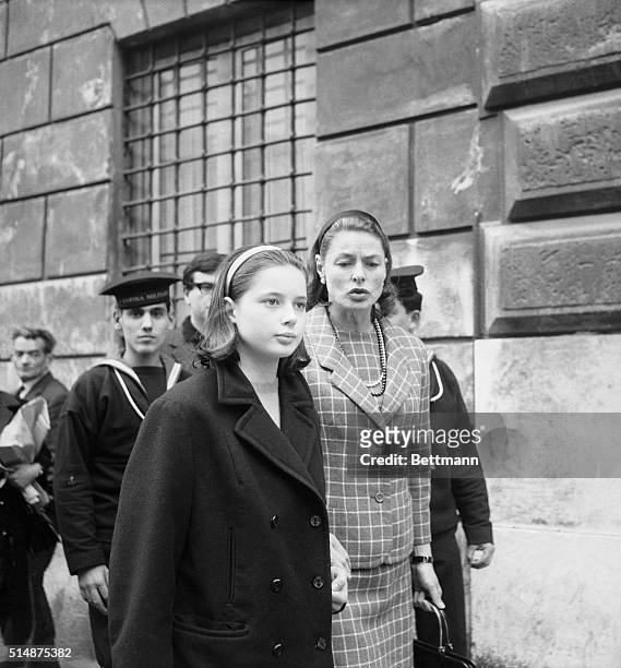 Rome:Looking just like a mother, Ingrid Bergman clutches her daughter, Isabella's hand as she convoys the 13-year old past some sailors during a...
