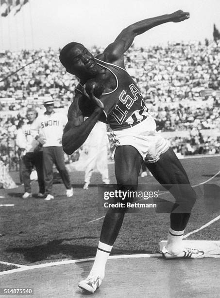 Decathlete Rafer Johnson throws the shot put during the Decathlon at the Rome Olympics in 1960. Johnson won the gold medal in the Decathlon.