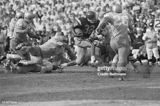 Simpson scores his second touchdown for USC in a game against UCLA. USC wins the game 21-20