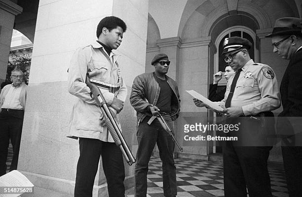 Two members of the Black Panther Party are met on the steps of the State Capitol in Sacramento, May 2 by Police Lt. Ernest Holloway, who informs them...