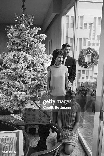 California Governor Ronald Reagan and his family gaze out the window after putting the finishing touches on their Christmas tree 12/22. Family Ronald...