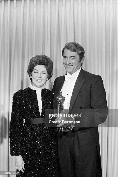 Gregory Peck with the Jean Hersholt Humanitarian Award he received at the 1968 Academy Awards, and actress Rosalind Russel, who presented to him.