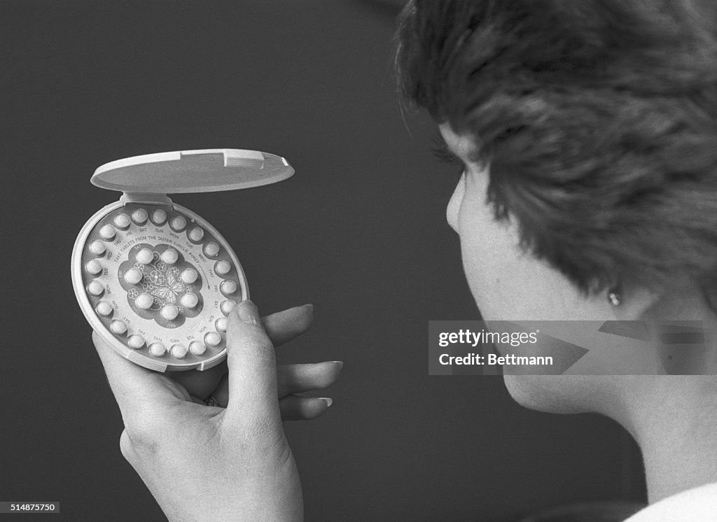 Woman Holding Birth Control Pills