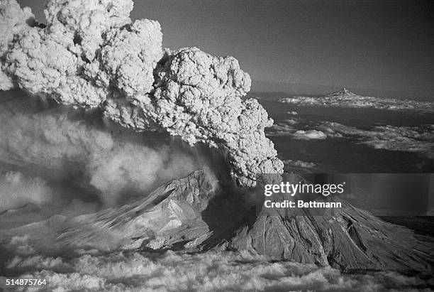 "BLOWS TOP AGAIN." SPIRIT LAKE,WASH.: WITH MOUNT HOOD VISIBLE IN THE BACKGROUND, MOUNT ST.HELENS ERUPTS JULY 22. THE PLUME OF STEAM AND ASH ROSE SOME...