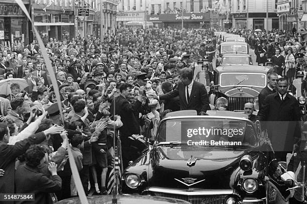 Irish-American president John F. Kennedy rides through a huge crowd in Cork, Ireland, shaking hands all the way. Earlier in the day, the president...