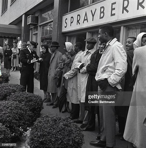 Police officer records the names of African American students who attempted a sit down protest at a lunch counter in Atlanta, Georgia.