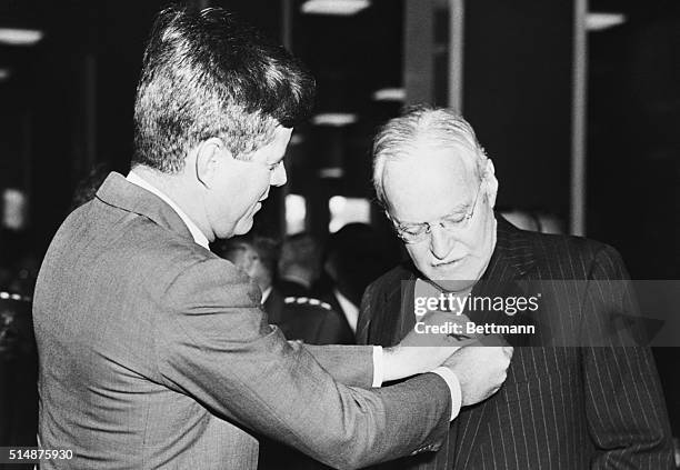 President John F. Kennedy presents the National Security Award to the Director of the Central Intelligence Agency, Allen Dulles, who resigned in 1961.