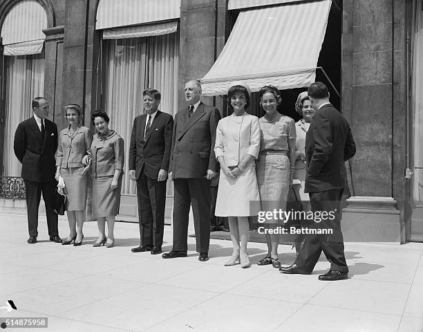 French President Charles De Gaulle stands between U.S. President John F. Kennedy and Mrs. Kennedy on the steps of the Elysee Palace after luncheon...