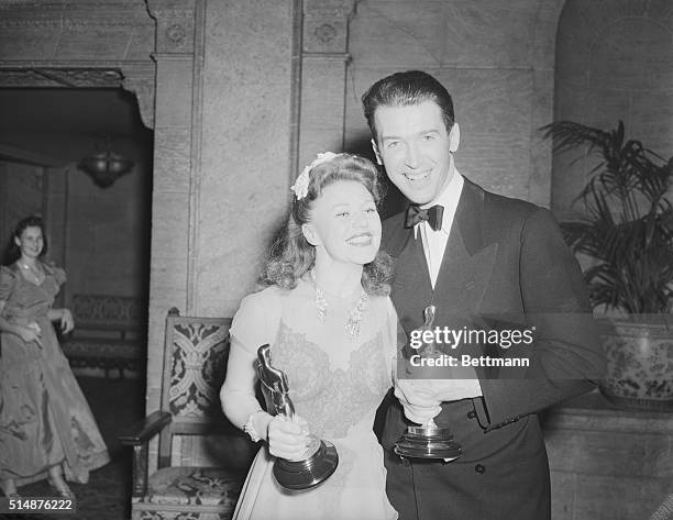 Ginger Rogers and Jimmy Stewart gaze appreciatively into each others eyes after each had been awarded an Oscar at the annual Motion Picture Academy...