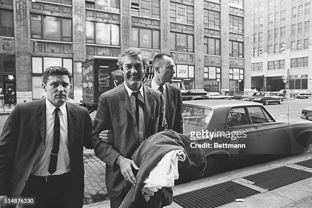 New York: In the custody of customs officials Dr. Timothy Leary is led into U.S. Customs house here Oct. 11, following his arrest at La Guardia...