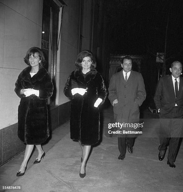 New York, NY: Wearing similar coats, Mrs. Jacqueline Kennedy and her sister Princess Radziwill walk near Hotel Carlyle with unidentified Secret...