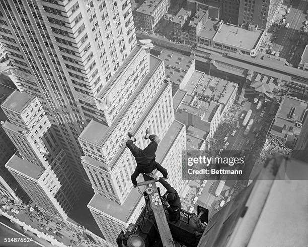 Alvin "Shipwreck" Kelly celebrates Friday the 13th by sitting on his head on a board stuck out from the 54th floor of the Chanin Building, and...