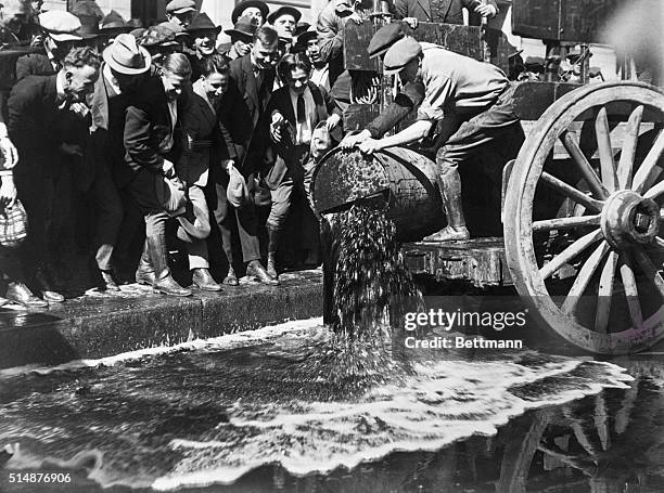 Los Angeles, California: U.S. Federal Agents pouring choice wines into the gutter in front of the Federal Building, Los Angeles. 900 gallons of booze...