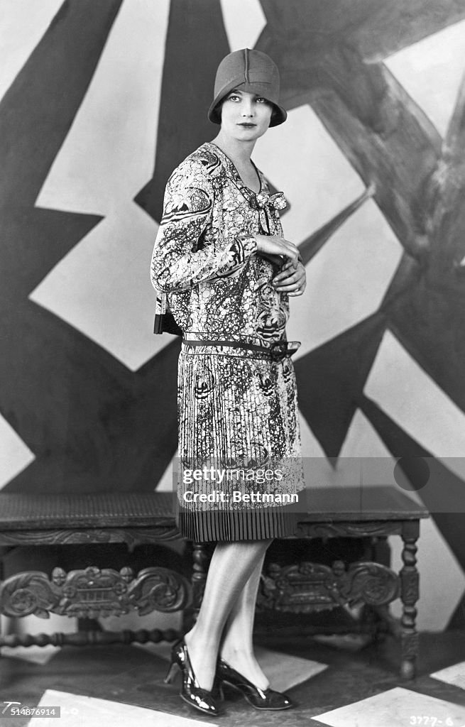 Woman Wears Dress and Hat From the 1920s