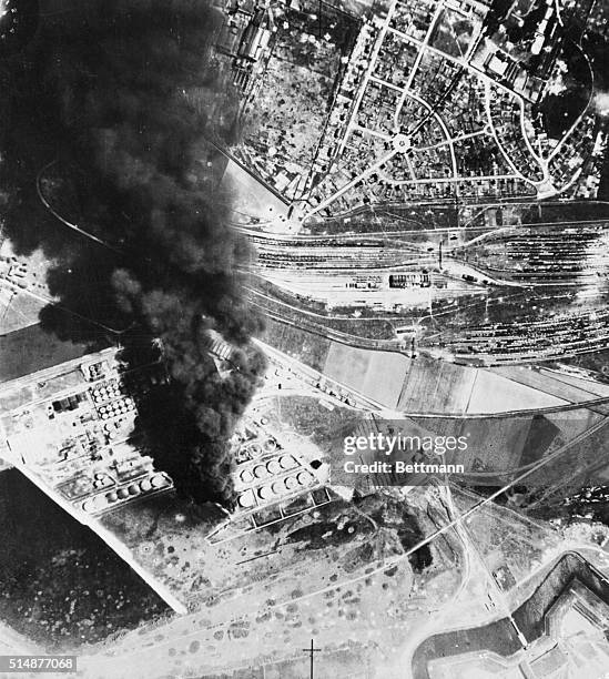 France: British official photograph. A dense plume of acrid black smoke rising several thousand feet masks a burning oil tank destroyed by the R.A.F....