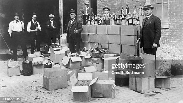 Revenue agents during raid on speak-easy, prohibition period. Photo, Washington, April 25, 1923.