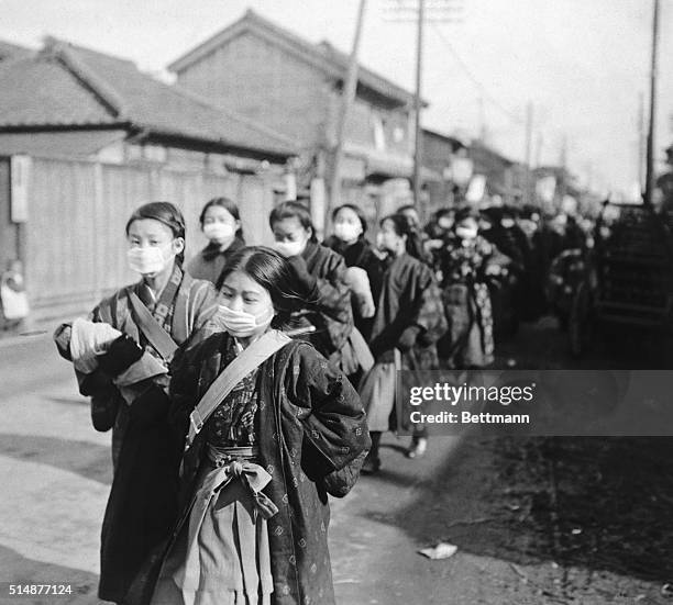 Japanese school girls wear protective masks to guard against the influenza outbreak.