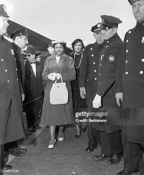 New York, NY: Autherine Lucy, expelled today from the University of Alabama, is shown walking from the plane that brought her to Laguardia Airport...