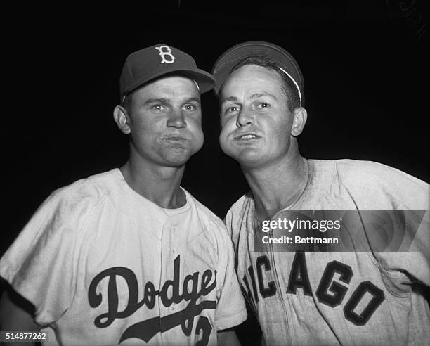 Nelson Fox of the Brooklyn Dodgers and Don Zimmer of the Chicago White Sox chewing tobacco.