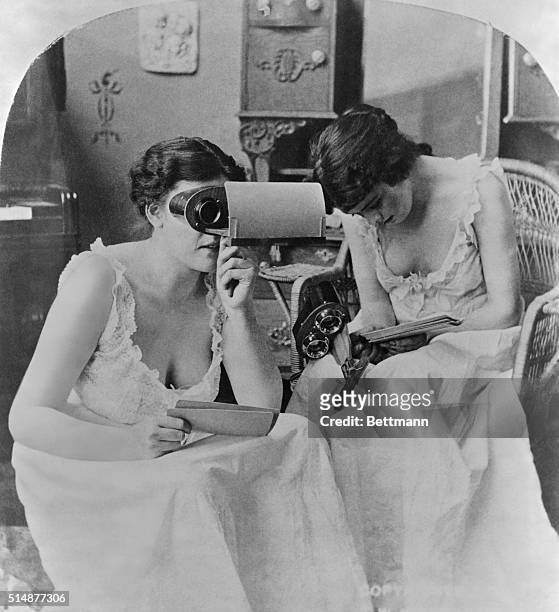 Two young ladies studying stereopticon pictures. Photograph, ca. 1900. BPA2#3678.