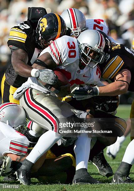Lydell Ross of Ohio State is tackled by Abdul Hodge and Chad Greenway of Iowa October 16, 2004 at Kinnick Stadium in Iowa City, Iowa.