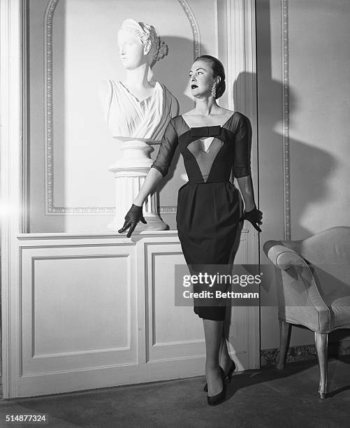 New York: This Oleg Cassini cocktail dress was featured in the Spring showing of the couture group of the New York Dress Institute. The black crepe...