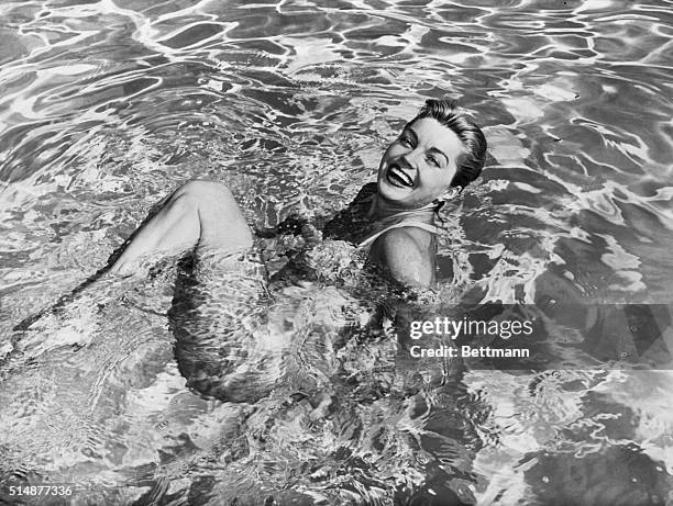 Esther Williams swimming in pool.