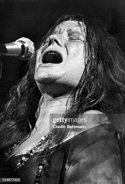 Janis Joplin , American rock singer, and electrifying performer. Head and shoulders photograph during a performance, ca. 1969.