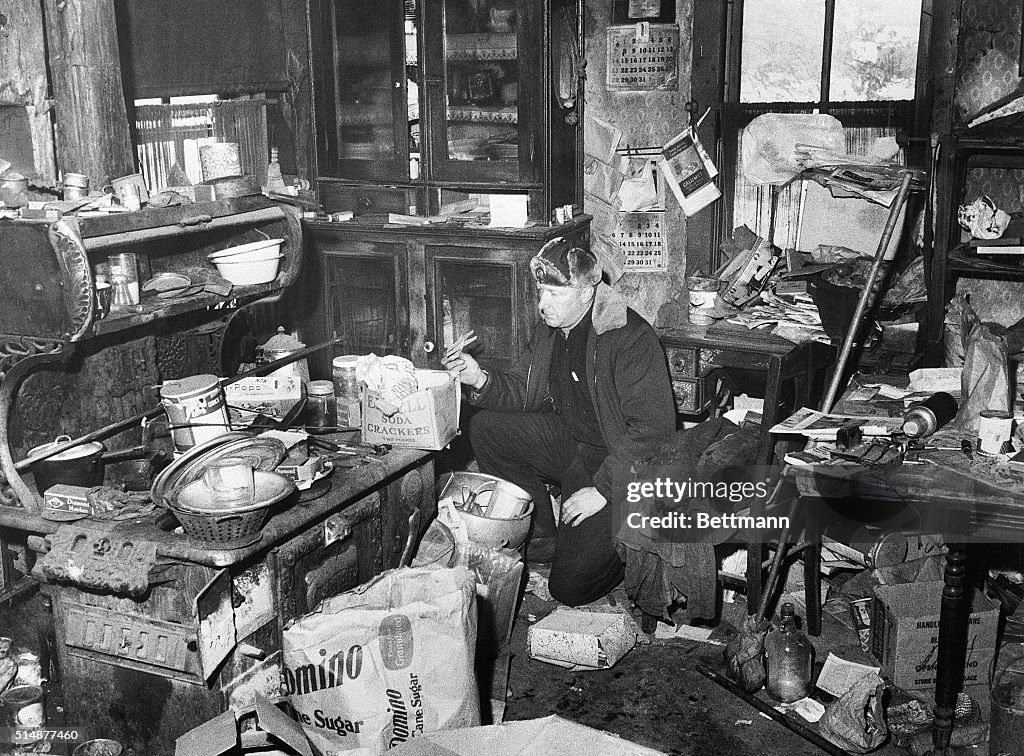Policeman Searching Littered Kitchen of Ed Gein