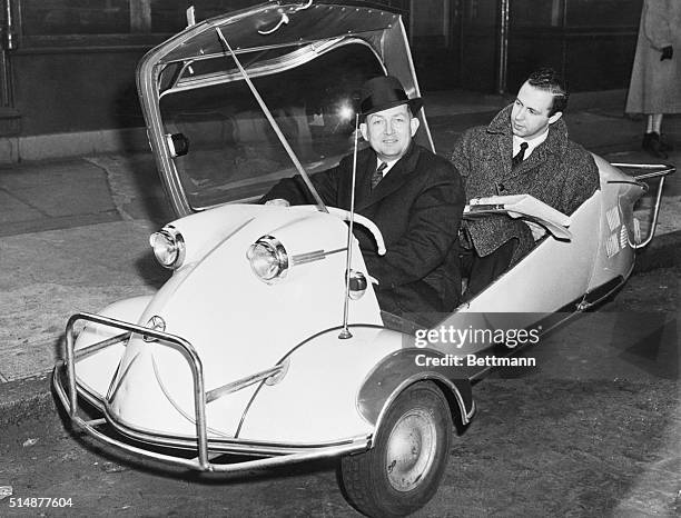 New York, NY: Reverend Walter Allen dealey, an associate Minister of the marel collegiate church, demonstrates that his three wheel Messerschmitt...
