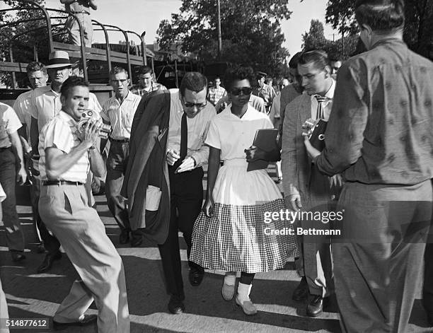 Elizabeth Eckford, one of the Little Rock Nine, is surrounded by journalists after she is prevented from entering Little Rock's Central High School...