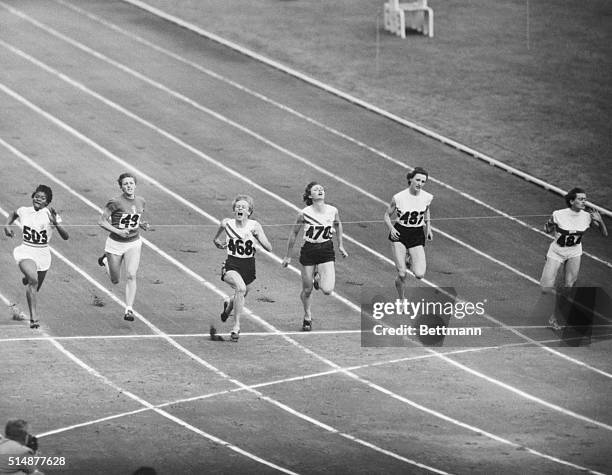 Melbourne, Australia: Australia's Betty Cuthbert third from left crosses the finish line to win the Women's Final 100 Meter in the Olympic Games....